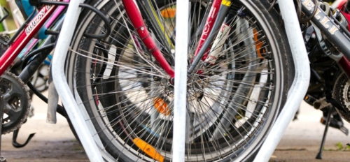 a close up of several bicycles parked on a sidewalk